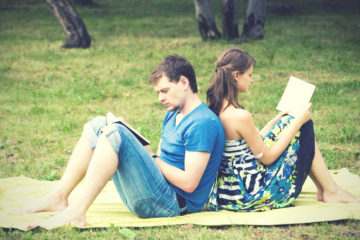 couple reading in a park in the summer